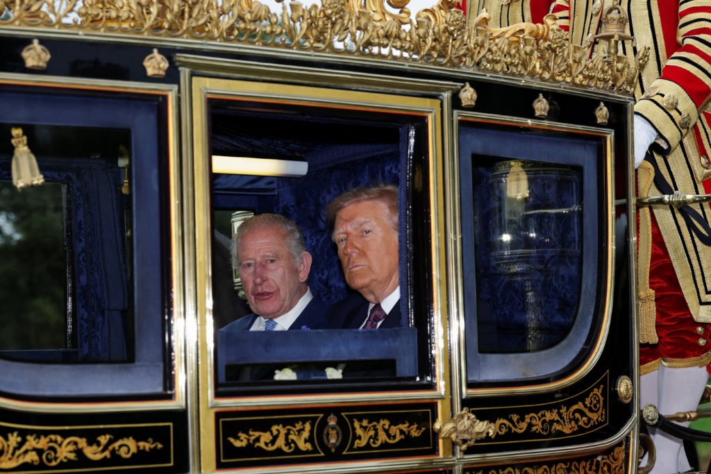 Britain's King Charles and U.S. President Donald Trump sit in a carriage during a procession through Windsor Castle, in Windsor, Britain, September 17, 2025. REUTERS/Toby Melville/Pool     TPX IMAGES OF THE DAY